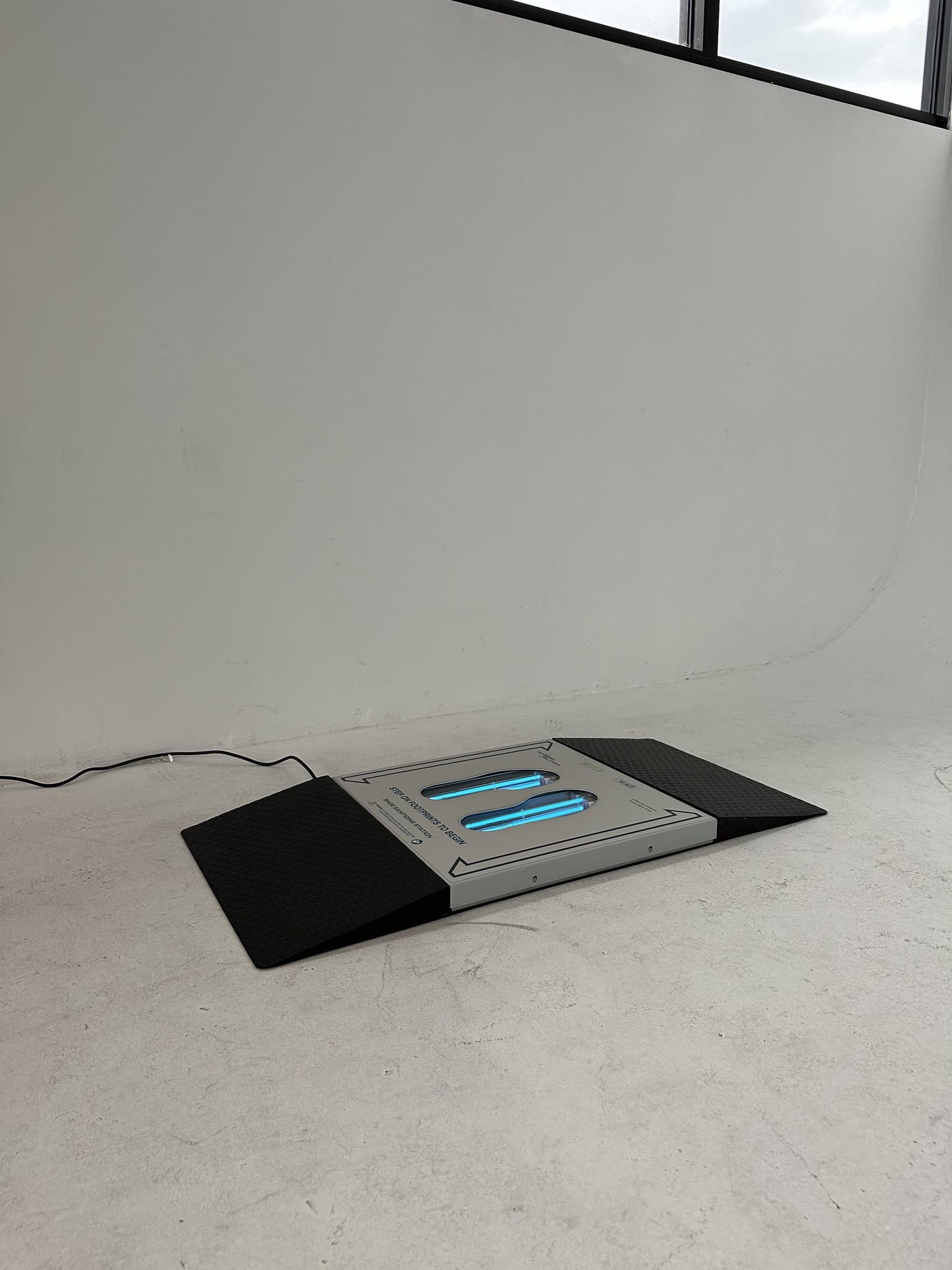 UVZone shoe sanitizing station with entry and exit ramps, photographed from an angle